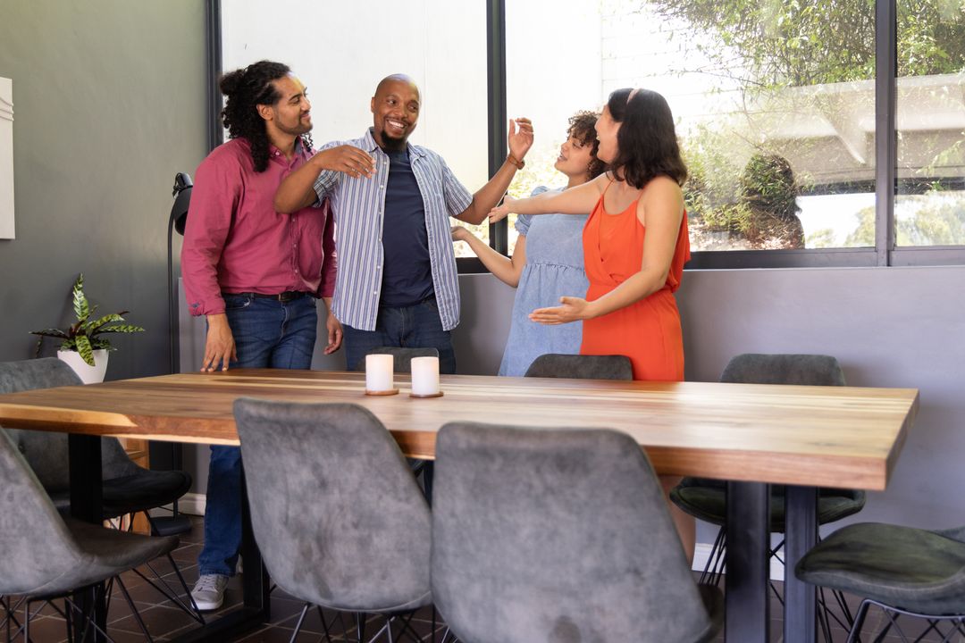 Diverse Colleagues Embrace with Joy in Modern Office Space
