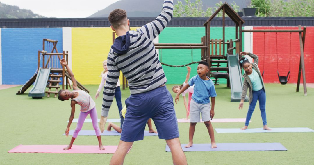 Teacher Leading Diverse Group of Kids in Outdoor Stretching Exercises - Free Images, Stock Photos and Pictures on Pikwizard.com