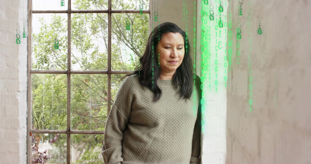 Woman leaning at metal window contemplating with green binary overlay and soft daylight