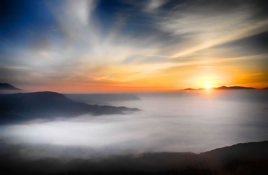 Sunrise Over Misty Mountain Range with Clouds and Sun Rays - Free Images, Stock Photos and Pictures on Pikwizard.com