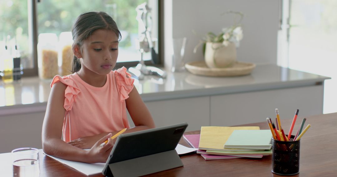 Young Girl Learning Computational Skills on Tablet at Home