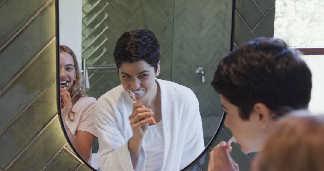 Smiling Couple Brushing Teeth Together in Modern Bathroom - Free Images, Stock Photos and Pictures on Pikwizard.com