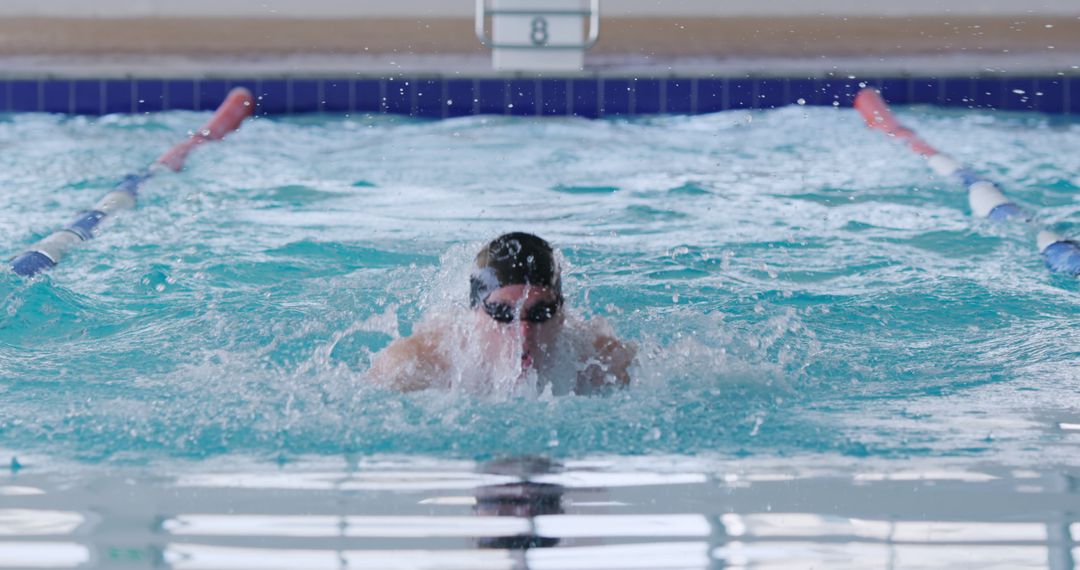 Male Swimmer Practicing Breaststroke in Indoor Pool - Free Images, Stock Photos and Pictures on Pikwizard.com