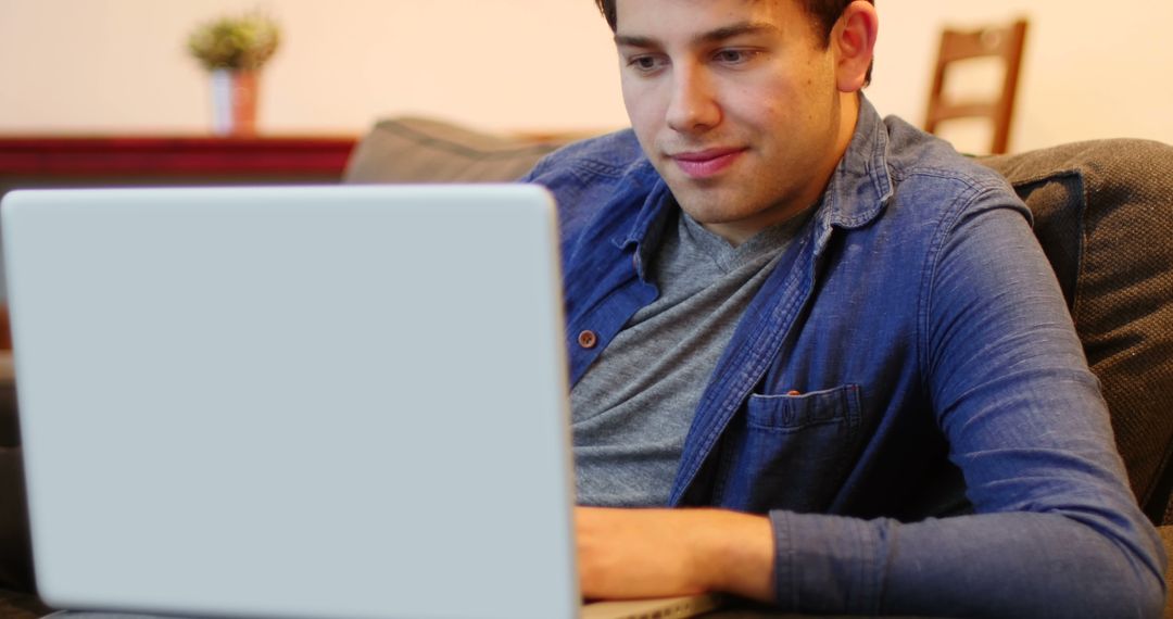 Focused Young Adult Man Using Laptop from Home - Free Images, Stock Photos and Pictures on Pikwizard.com