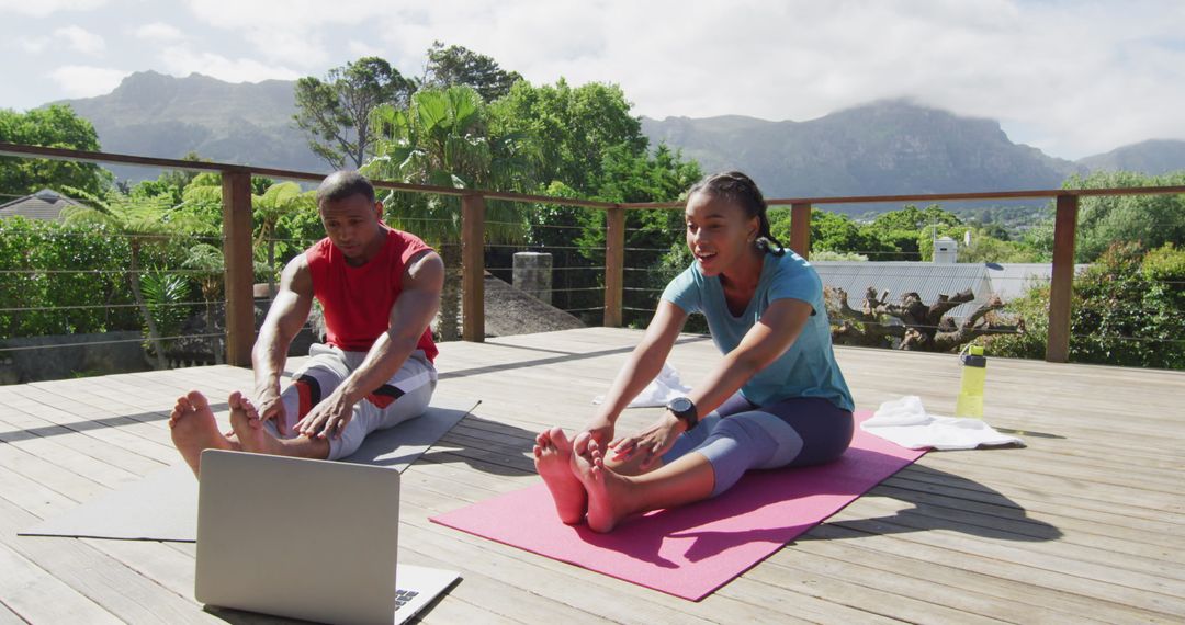 Couple Practicing Yoga on Outdoor Deck with Online Guidance