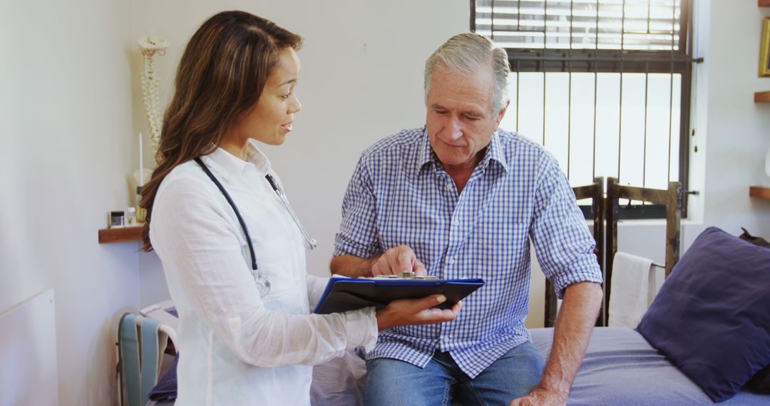 Doctor Discussing Diagnosis with Senior Patient in Clinic - Free Images, Stock Photos and Pictures on Pikwizard.com