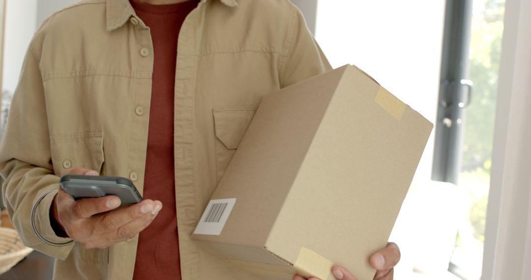 Man Checking Delivery Details with Smartphone at Home