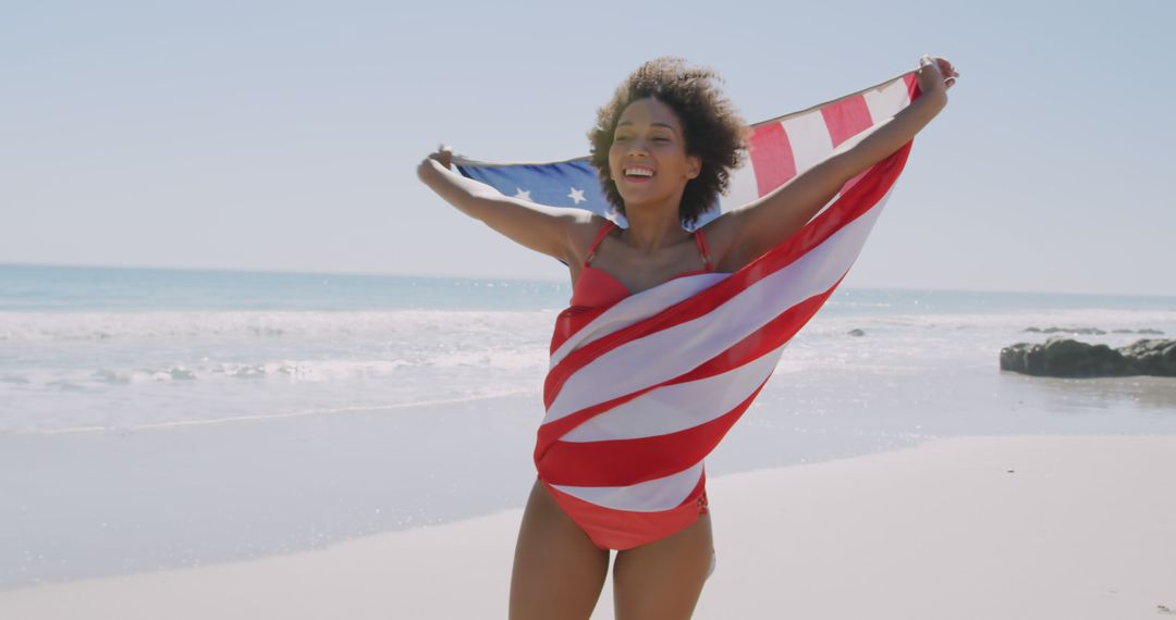 Cheerful Woman at Beach Holding American Flag in Sunlight - Free Images, Stock Photos and Pictures on Pikwizard.com