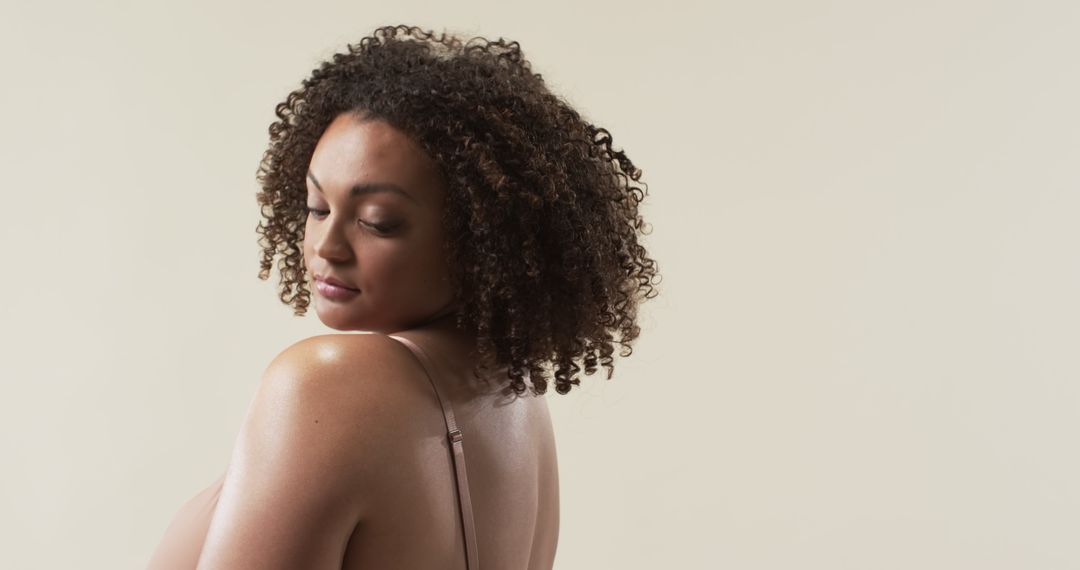 Confident Plus Size Woman with Natural Curls Smiling Gently