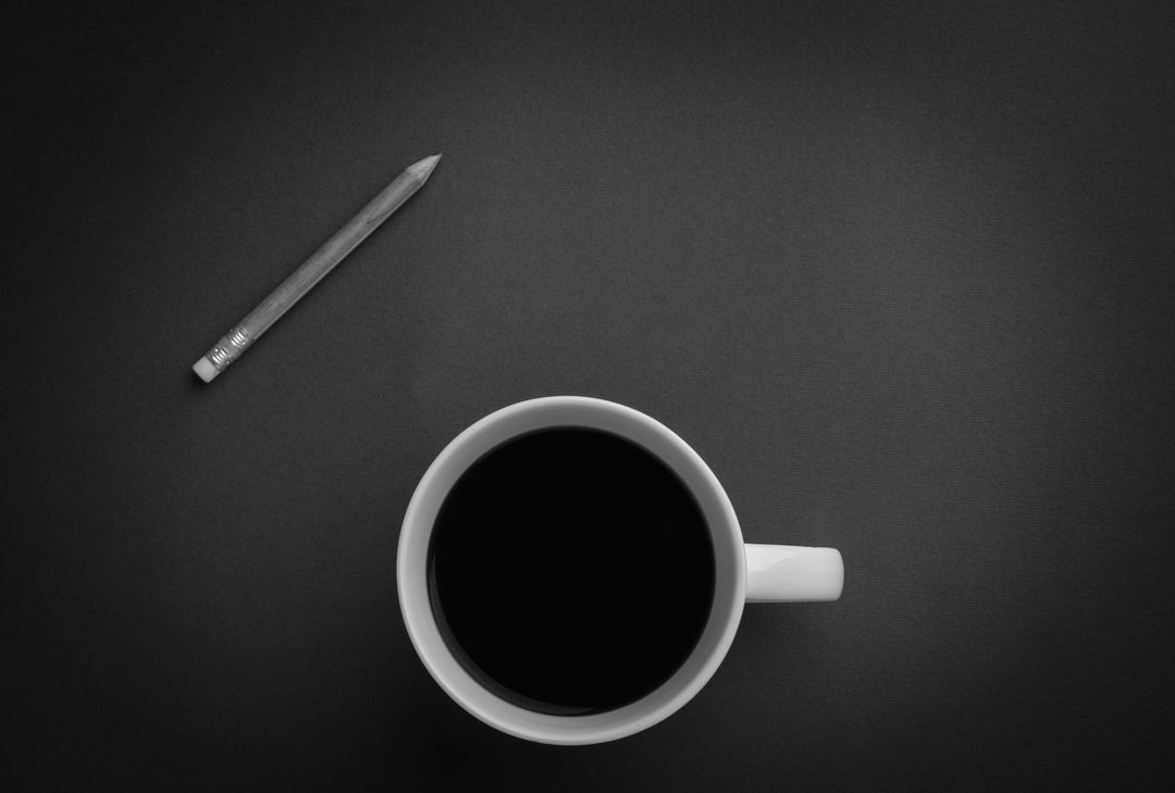Minimalist Black Coffee Cup and Pencil on Dark Desk - Free Images, Stock Photos and Pictures on Pikwizard.com