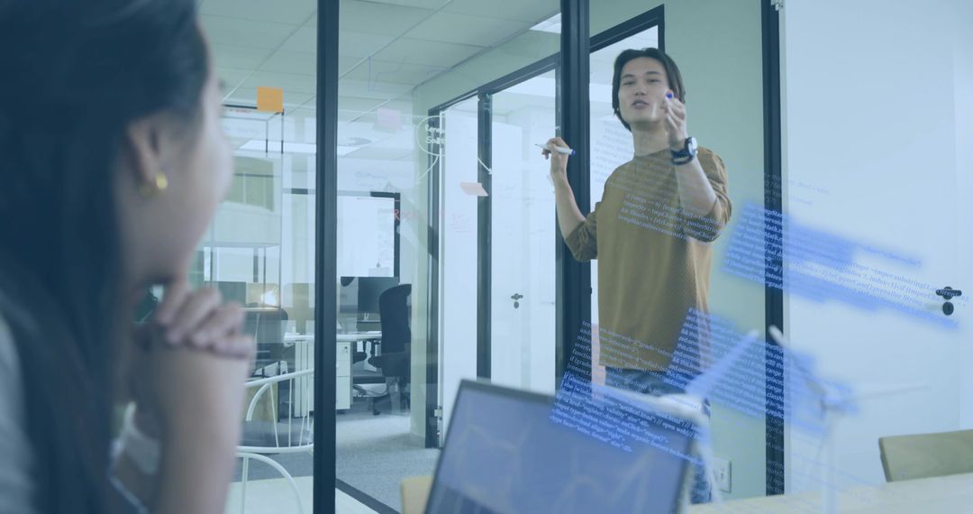 Engineer Presenting Code Diagram to Colleague in Modern Office