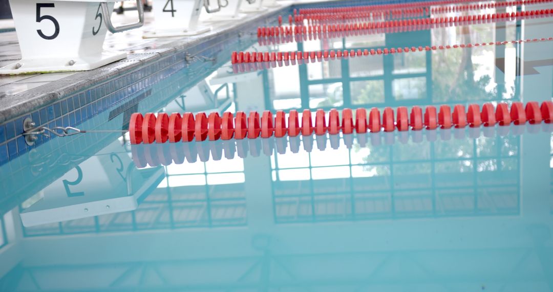 Indoor Swimming Pool with Reflections and Red Lane Dividers