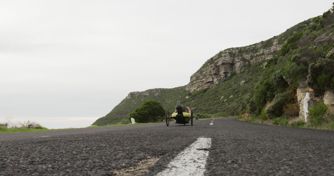 Handcyclist Riding on Scenic Mountain Road - Free Images, Stock Photos and Pictures on Pikwizard.com