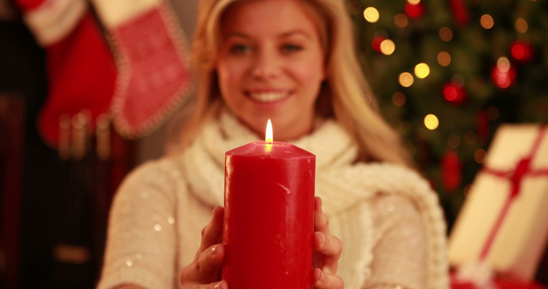 Woman Holding Red Candle in Festive Christmas Setting - Free Images, Stock Photos and Pictures on Pikwizard.com