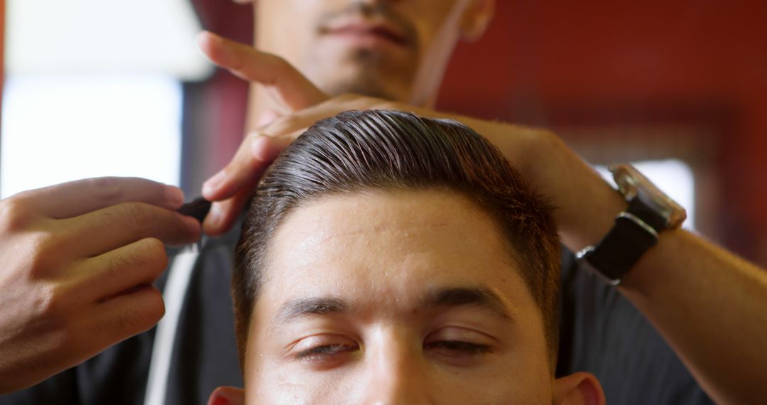 Close-up of Barber Combing Young Man's Hair - Free Images, Stock Photos and Pictures on Pikwizard.com