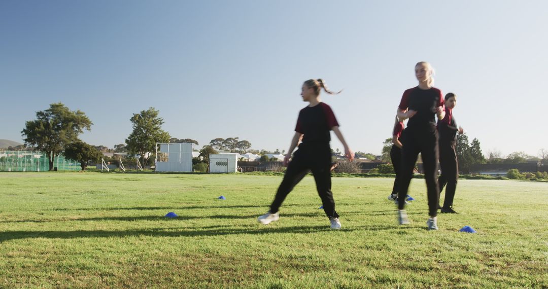 Female Athletes Practicing Drills on Sunny Field