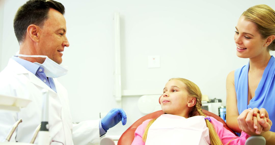 Young Girl at Dentist Office Holding Mother's Hand - Free Images, Stock Photos and Pictures on Pikwizard.com