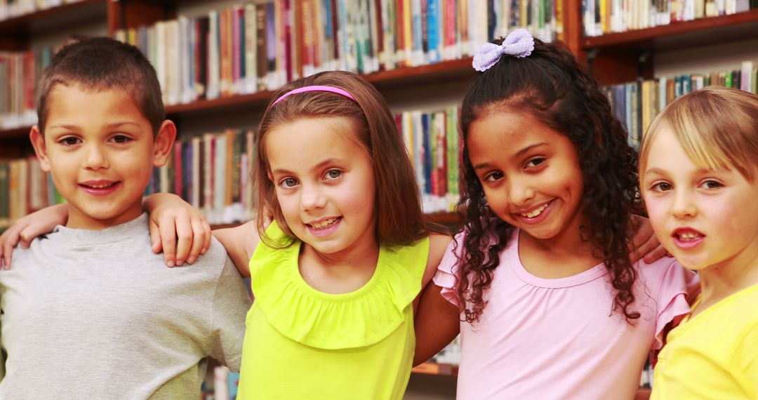 Diverse group of happy children hugging in library - Free Images, Stock Photos and Pictures on Pikwizard.com