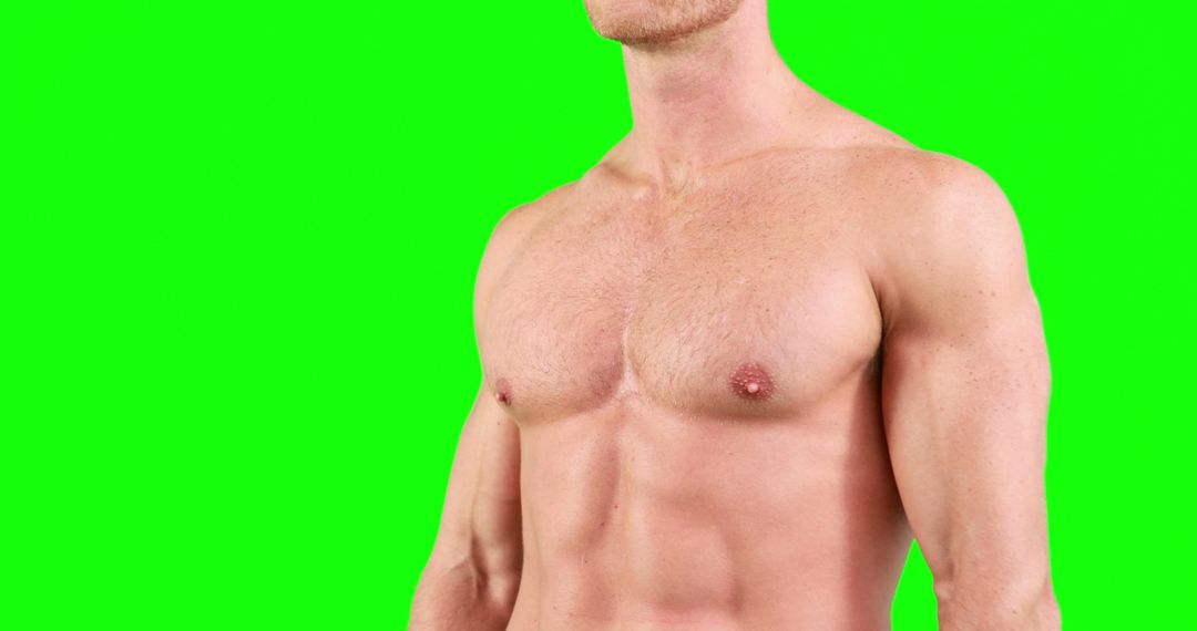 Fit man with muscular torso against green background - Free Images, Stock Photos and Pictures on Pikwizard.com