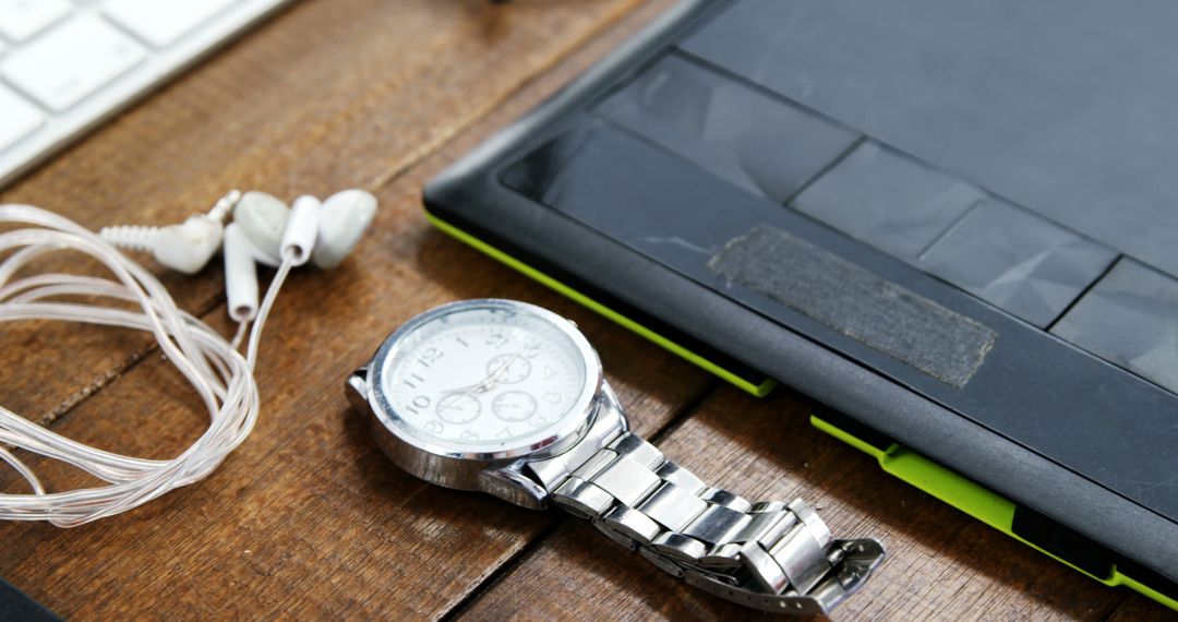 Modern Workspace with Watch, Headphones and Tablet on Wooden Desk - Free Images, Stock Photos and Pictures on Pikwizard.com