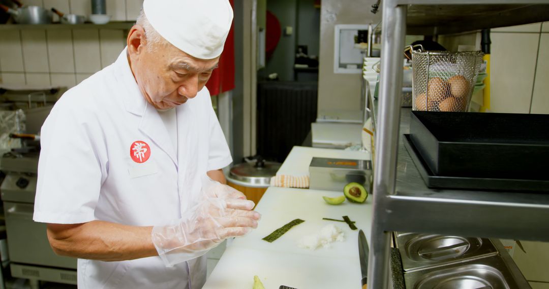 Experienced Chef Preparing Sushi in Japanese Kitchen - Free Images, Stock Photos and Pictures on Pikwizard.com