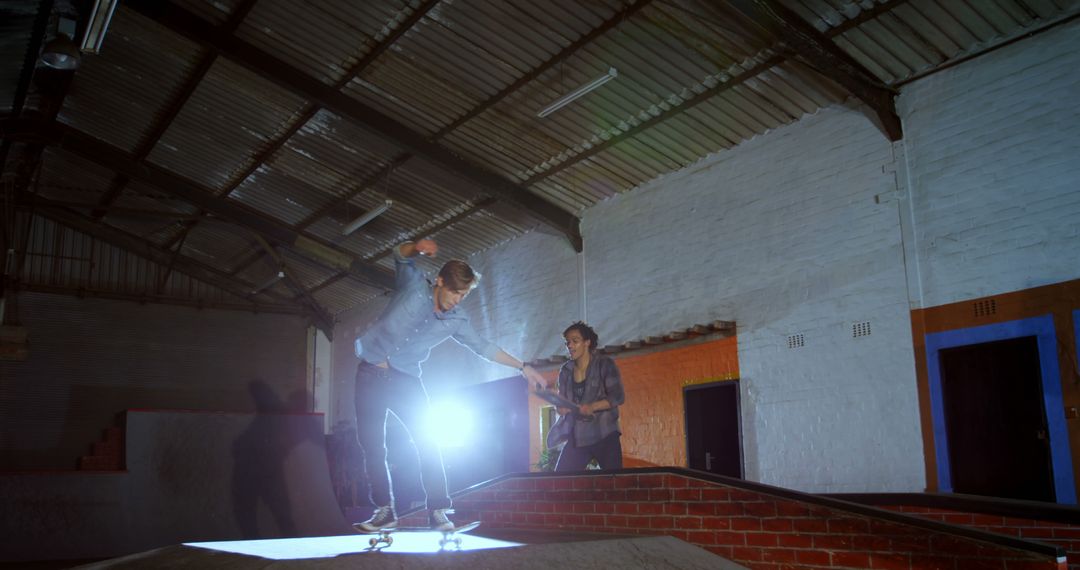 Teenage Friends Skateboarding Indoors in Low Light Environment - Free Images, Stock Photos and Pictures on Pikwizard.com