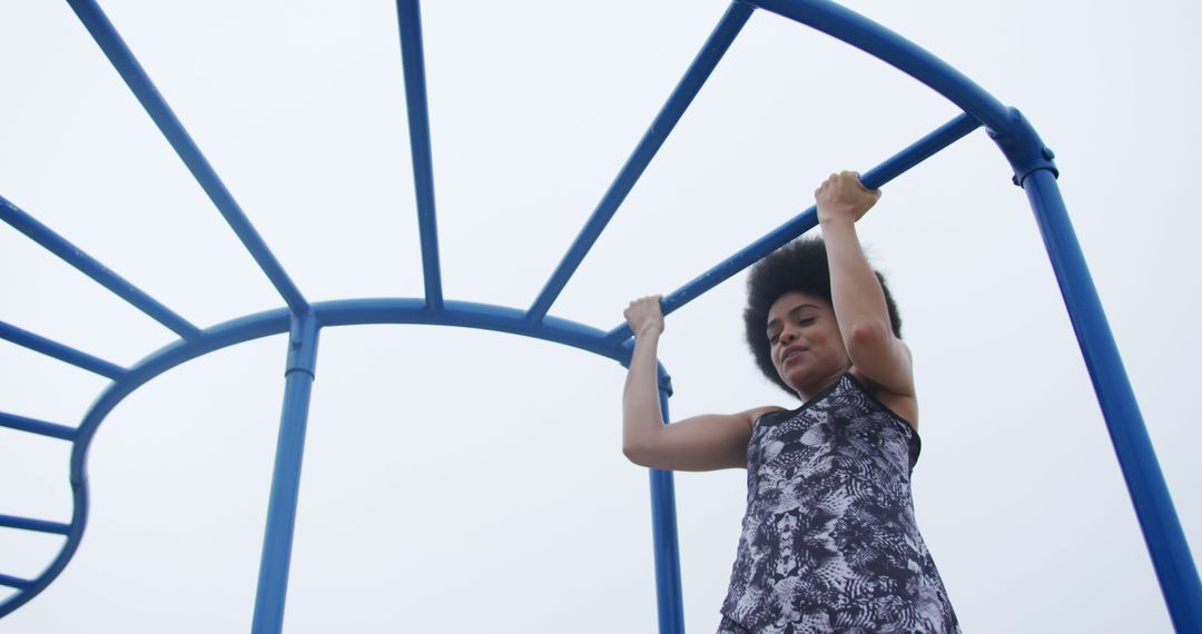 Active Woman Exercising on Gymnastic Bars Outdoors - Free Images, Stock Photos and Pictures on Pikwizard.com