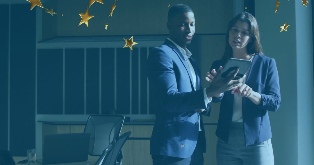 Professional Team Reviewing Tablet in Modern Office