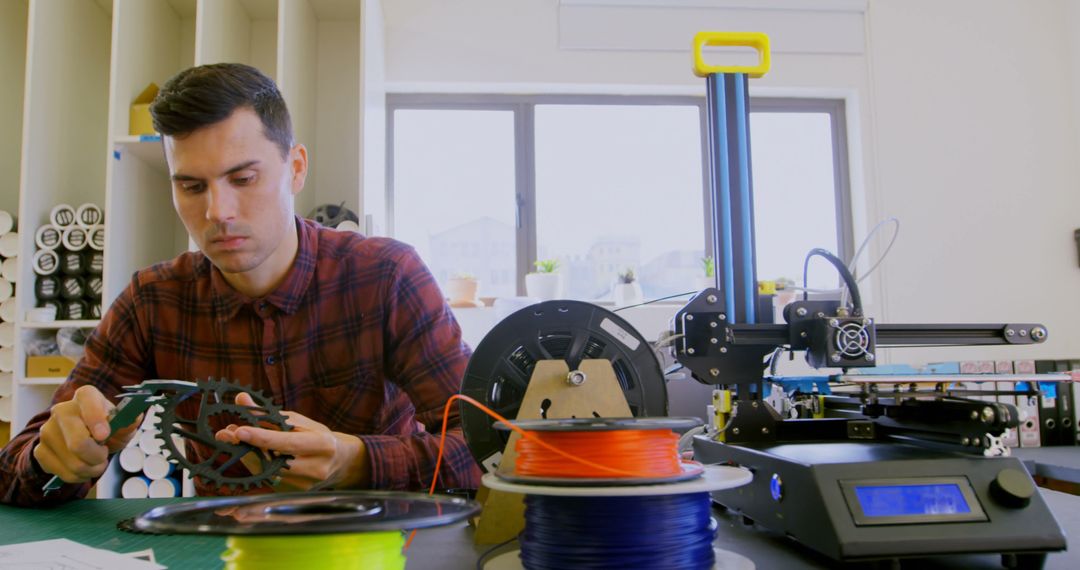 Engineer Evaluating 3D Print in Modern Workspace