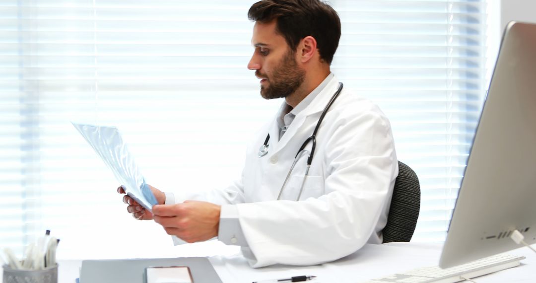 Male Doctor Analyzing Medical X-ray in Well-lit Office - Free Images, Stock Photos and Pictures on Pikwizard.com