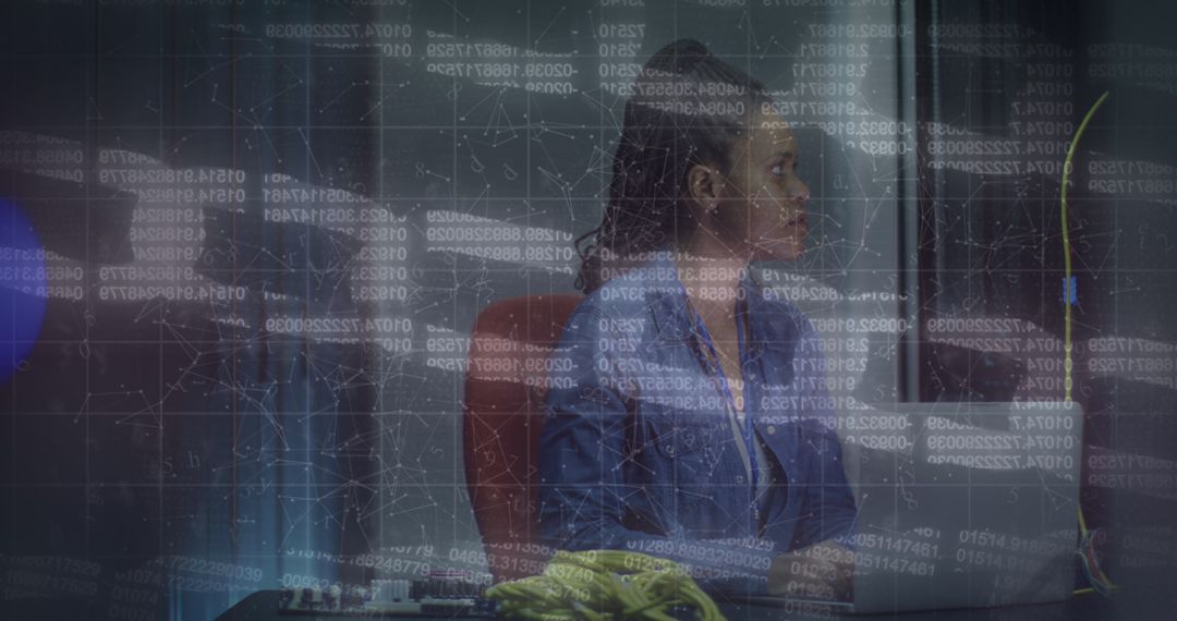 African American Woman Analyzing Data in Server Room Setting