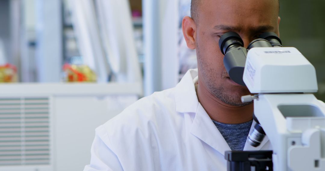 Scientist Conducting Research with Microscope in Laboratory - Free Images, Stock Photos and Pictures on Pikwizard.com