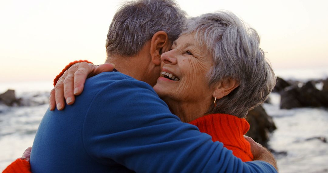 Senior Couple Embracing at Beach Sunset - Free Images, Stock Photos and Pictures on Pikwizard.com