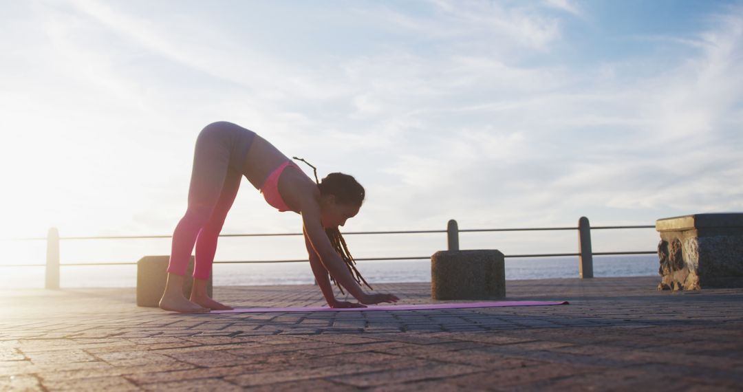 Woman Practicing Yoga at Sunrise on Seaside Promenade - Free Images, Stock Photos and Pictures on Pikwizard.com