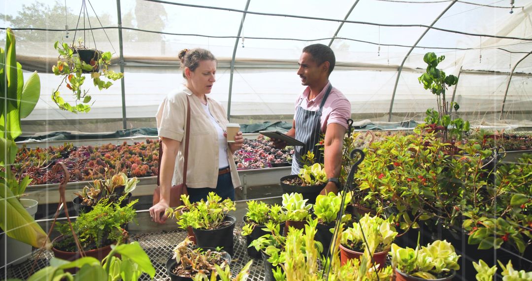 Gardening Enthusiast and Greenhouse Employee Discussing Cultivation