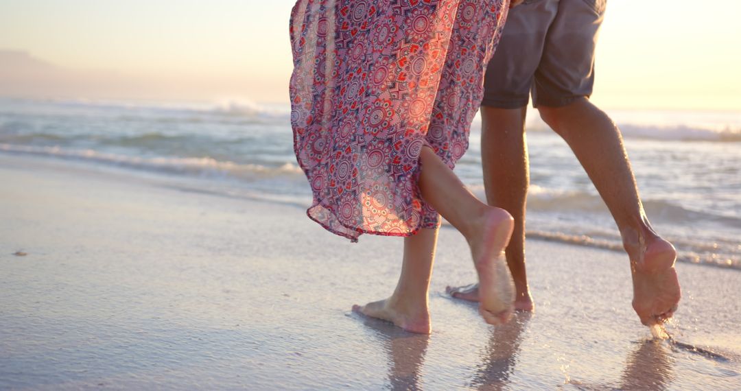 Romantic Beach Walk at Sunset Features Barefoot Couple