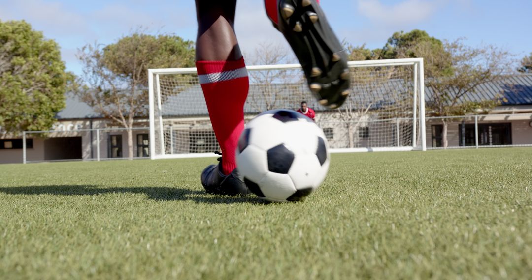 Dynamic Soccer Players Kicking Ball on Outdoor Field