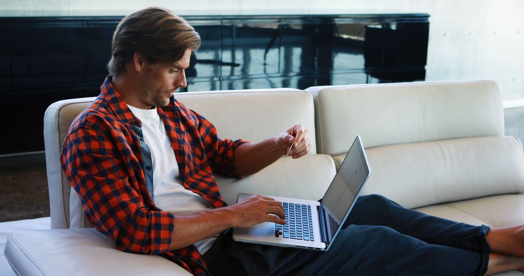 Man Relaxes at Home While Shopping Online with Laptop - Free Images, Stock Photos and Pictures on Pikwizard.com