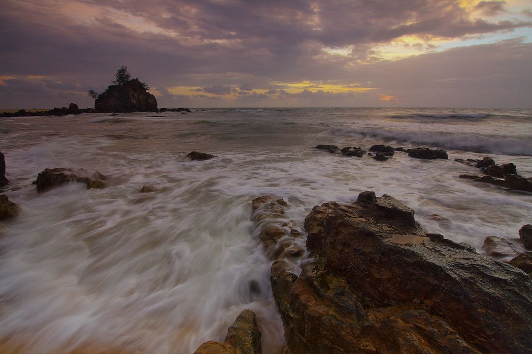 Sunset Over Rocky Shoreline with Gentle Waves - Free Images, Stock Photos and Pictures on Pikwizard.com