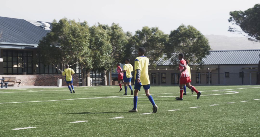 Youth Soccer Players Practicing Team Sport on Field