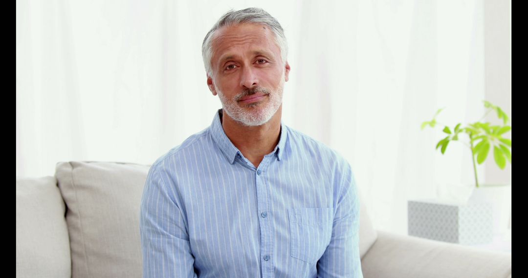 Middle-Aged Man Smiling in Cozy Living Room - Free Images, Stock Photos and Pictures on Pikwizard.com