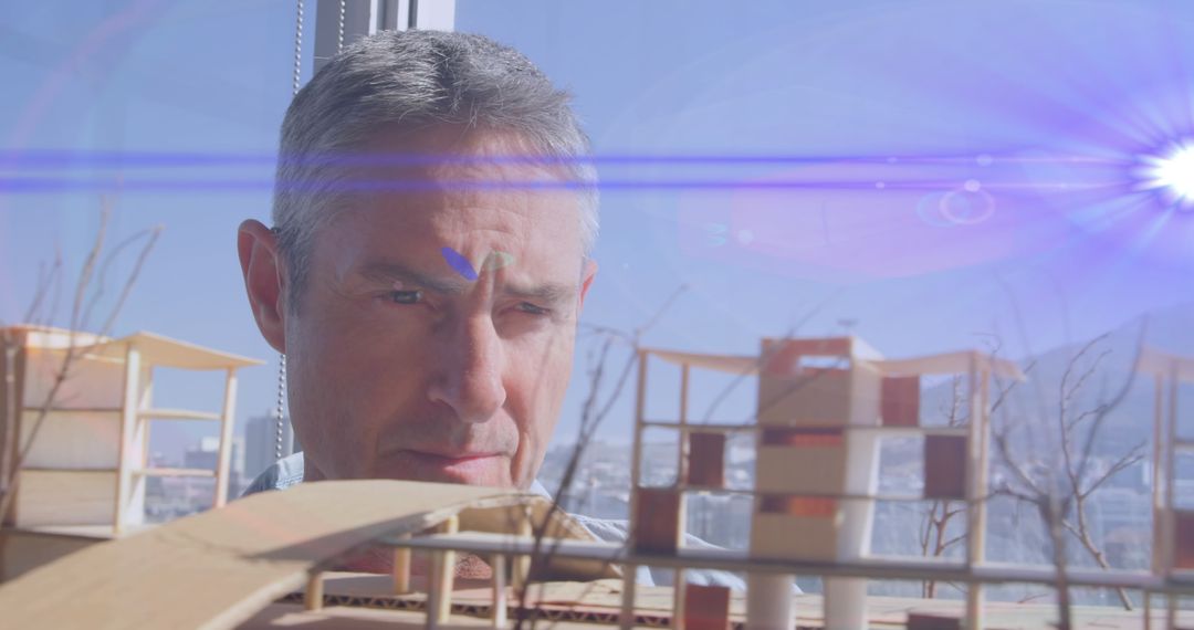 Architect Analyzing Architectural Model with Lens Flare Effect