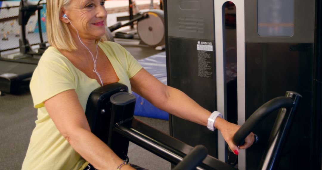 Senior Woman Exercising on Machine at Gym - Free Images, Stock Photos and Pictures on Pikwizard.com