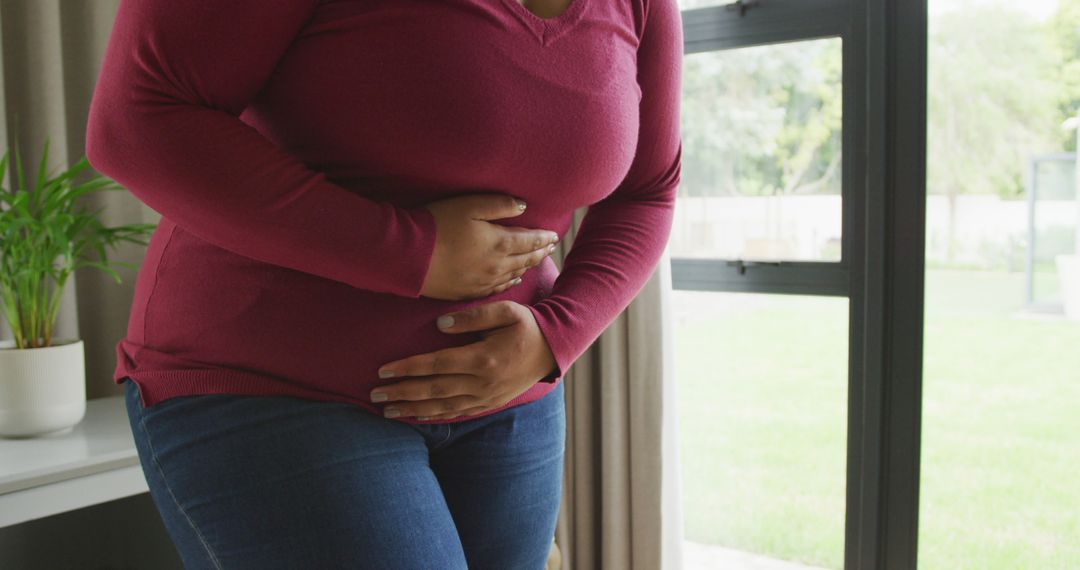 Image of midsection of plus size african american woman having stomach ache - Free Images, Stock Photos and Pictures on Pikwizard.com