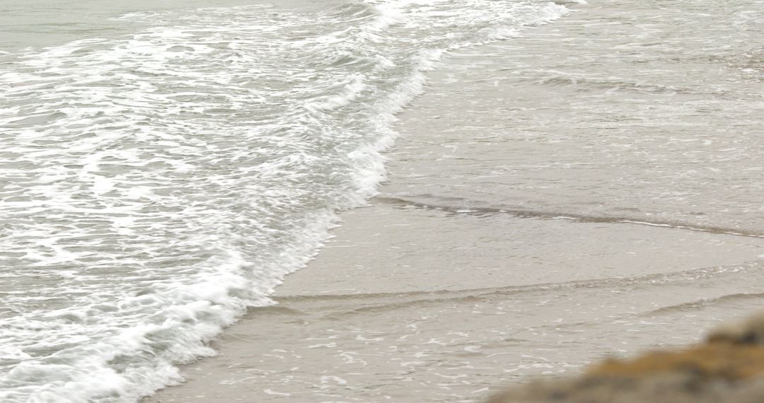 Gently Rolling Waves Reaching Sandy Shoreline - Free Images, Stock Photos and Pictures on Pikwizard.com