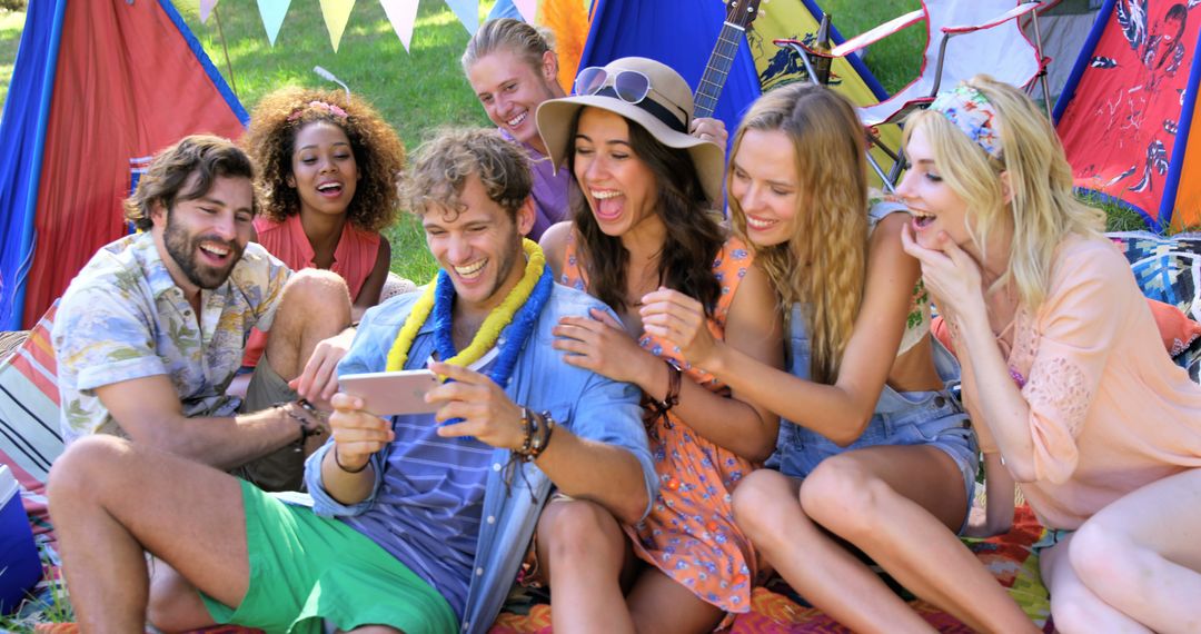 Group of Friends Watching Video on Smartphone at Outdoor Festival - Free Images, Stock Photos and Pictures on Pikwizard.com