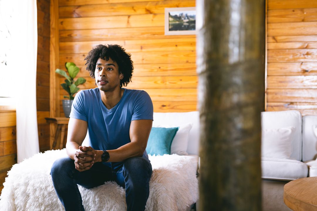 African American Man Relaxing in Cozy Log Cabin - Free Images, Stock Photos and Pictures on Pikwizard.com