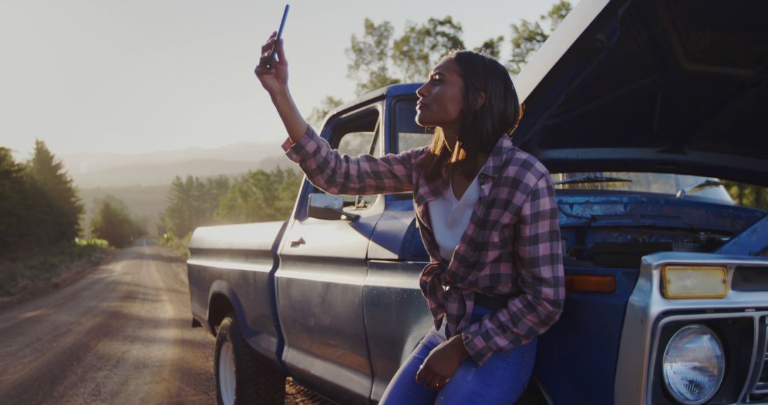 Young Woman Taking Selfie by Broken Down Truck on Country Road - Free Images, Stock Photos and Pictures on Pikwizard.com