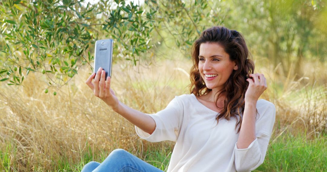 Woman Taking a Selfie Outdoors in a Nature Setting - Free Images, Stock Photos and Pictures on Pikwizard.com