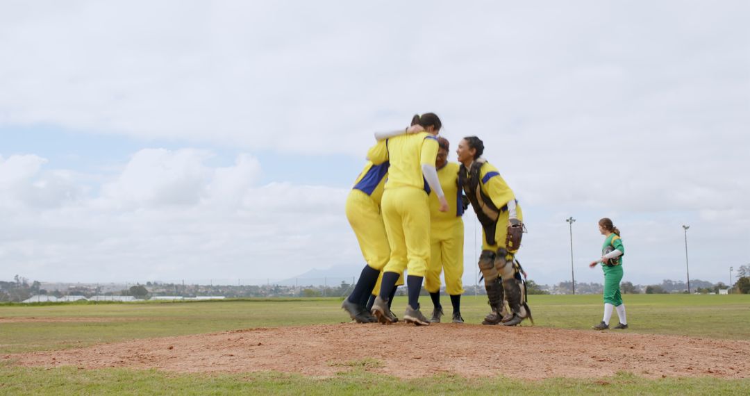 Dynamic Female Softball Team Celebrating on Pitcher's Mound